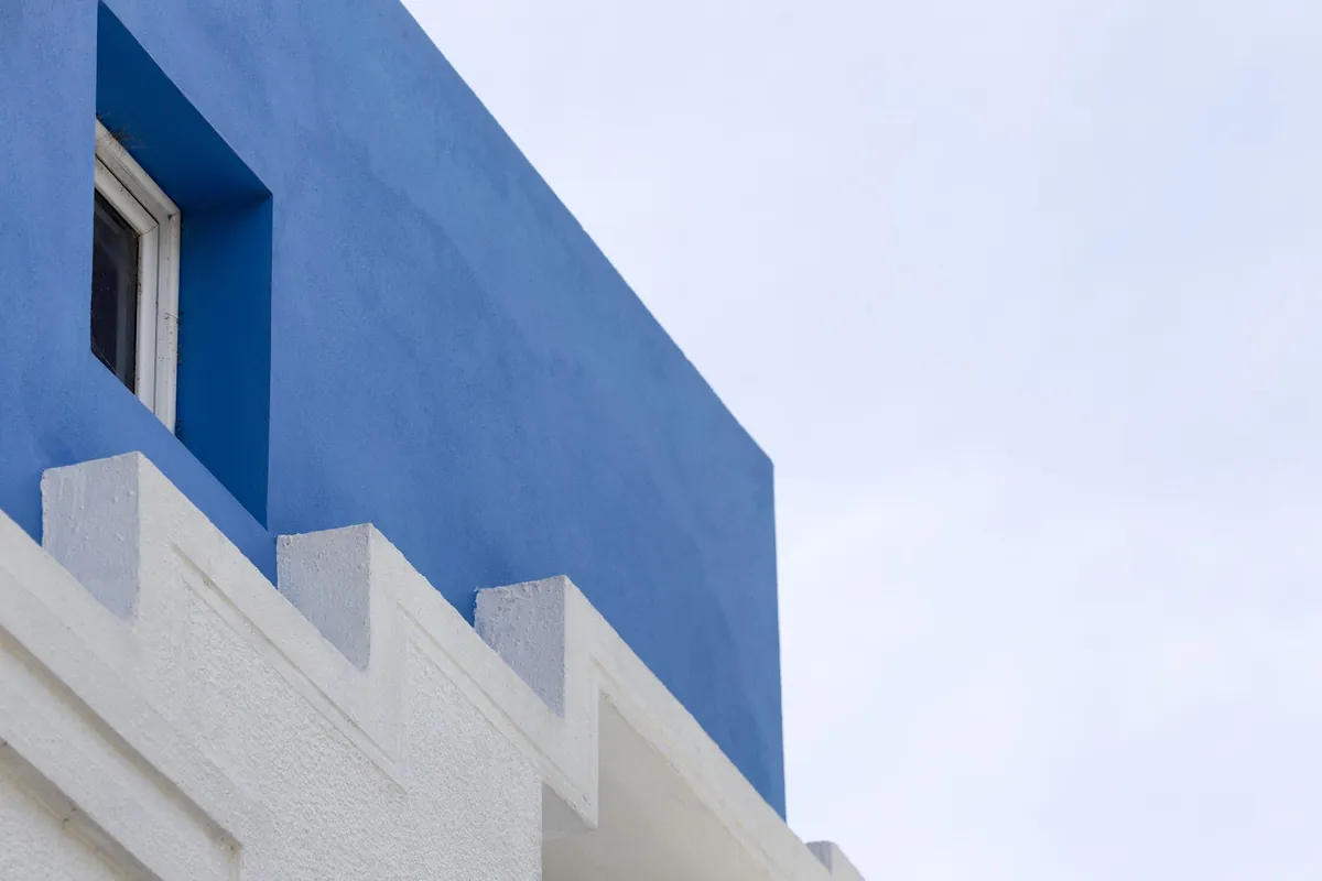 Deep blue stucco wall with white stepped detailing