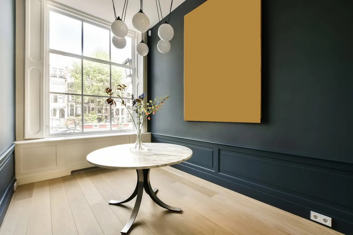 Dining room with a dark painted wall and wainscoting